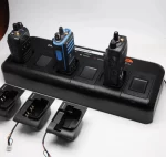 Two walkie talkies charging on a battery charger